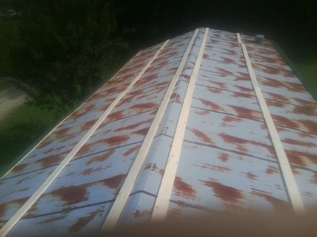 Rusted metal roof panels with new wood purlins before replacement — Storm Damage Roof Repair in Calhoun Falls by Roofing Brothers
