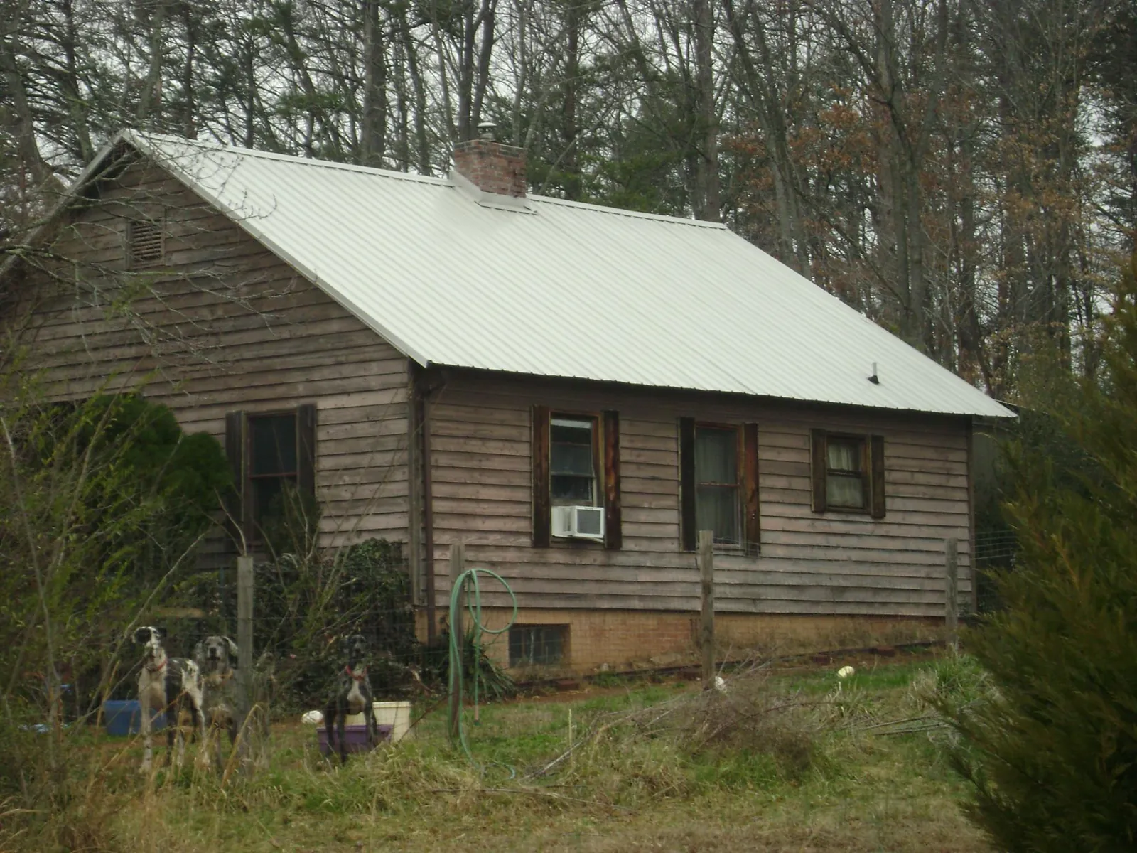 White metal roof on an old wood sided farmhouse, from a Metal Roof Installation job in Calhoun Falls